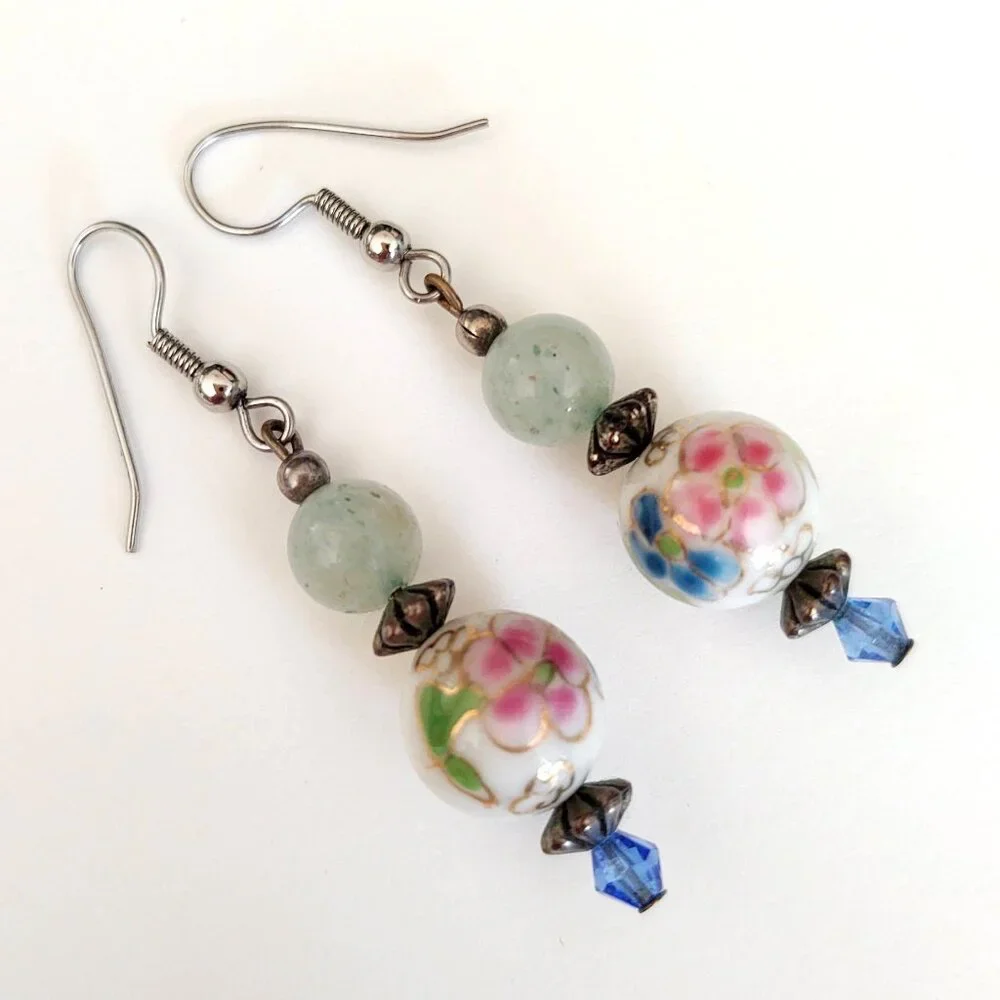 Floral painted ceramic beaded earrings with green and blue bead accents